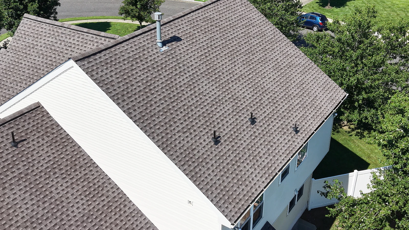 Close-up aerial documentation of a roof ridge, valley and vent penetrations