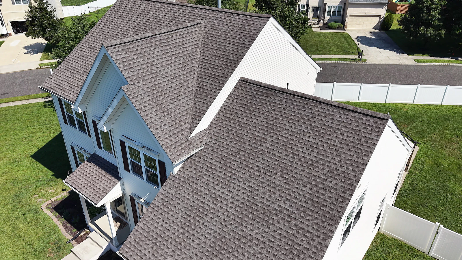 Aerial documentation of a two-story home's roofline, gables and front elevation